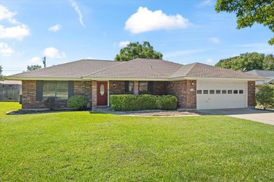 Single story home with a garage and a front yard | Image 1