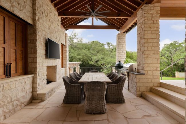 View of patio with an outdoor kitchen, outdoor dining area, and a gazebo | Image 29