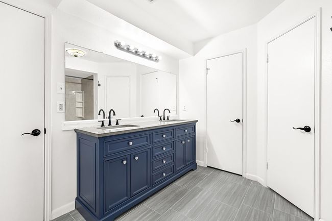 En-sute bath featuring dual vanity sinks. | Image 31