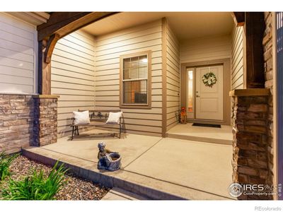 This spacious front porch is well-lit. There is plenty of room for benches or chairs, so you can relax in the evening and wave to your neighbors. | Image 2