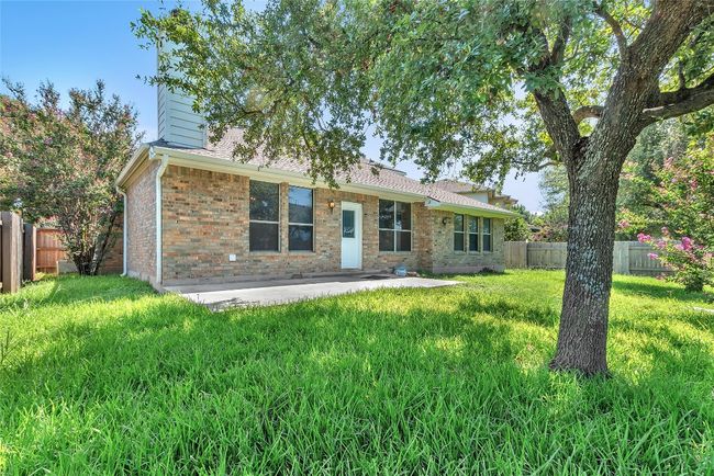 Ranch-style home featuring a fenced backyard, a patio, brick siding, a chimney, and roof with shingles | Image 30
