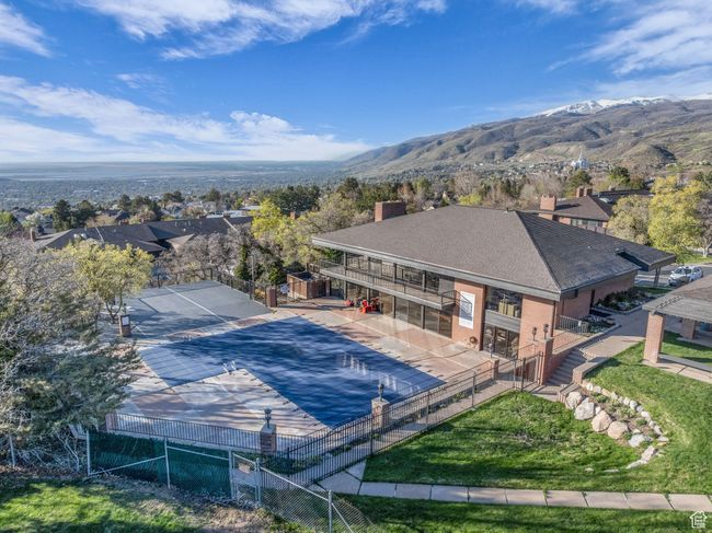 View of swimming pool featuring a mountain view and fence | Image 32