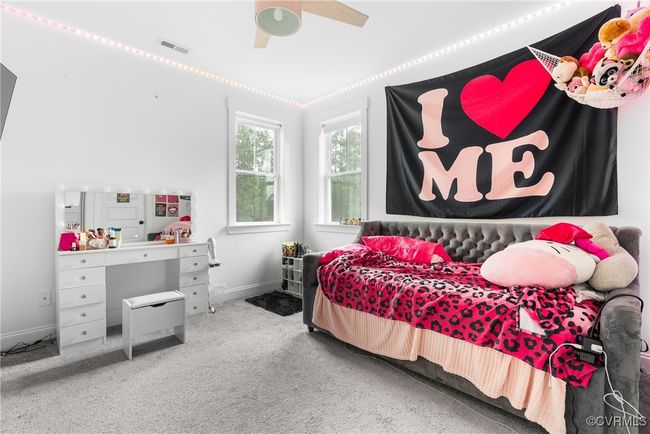 Carpeted bedroom featuring a ceiling fan and baseboards | Image 25