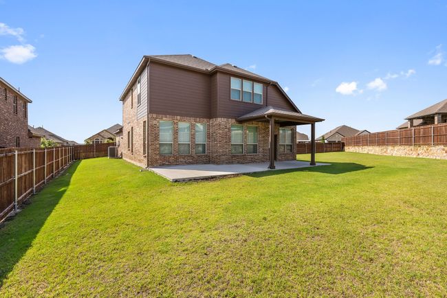 Rear view of property featuring a patio, a fenced backyard, and brick siding | Image 26