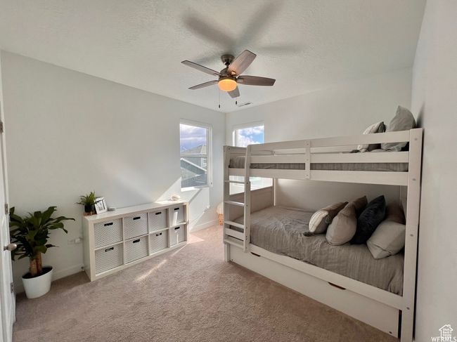 Carpeted bedroom featuring a textured ceiling and ceiling fan | Image 14