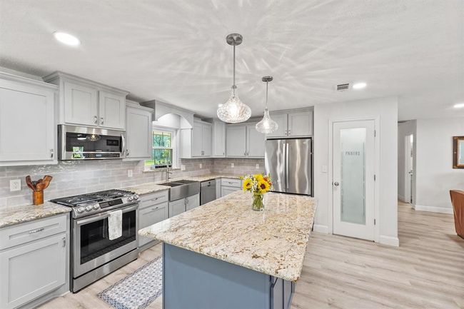 Granite countertop and backsplash detail emphasizing craftsmanship. | Image 7