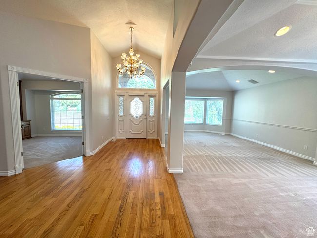 Foyer featuring lofted ceiling, plenty of natural light, arched walkways, and hardwood floors. | Image 4