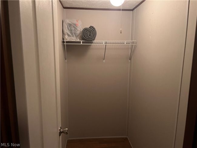 Spacious closet with hardwood / wood-style floors | Image 13