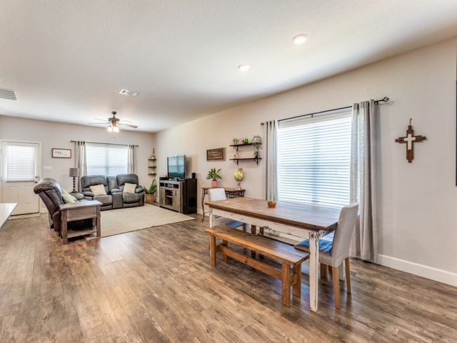 Dining space featuring wood finished floors and a ceiling fan | Image 9