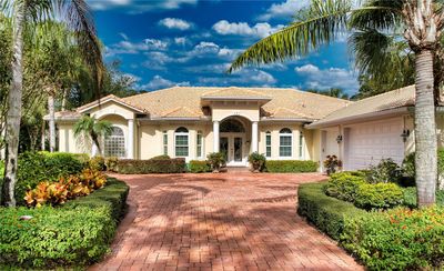 Experience the epitome of elegance with this exquisite home, featuring a durable tile roof and a spacious three-car side-entry garage. The beautifully pavered driveway offers a grand entrance to the property, complementing the home's refined architectural details and lush landscaping. This residence combines style with practicality, making it a perfect sanctuary for those who appreciate the finer things in life. | Image 2