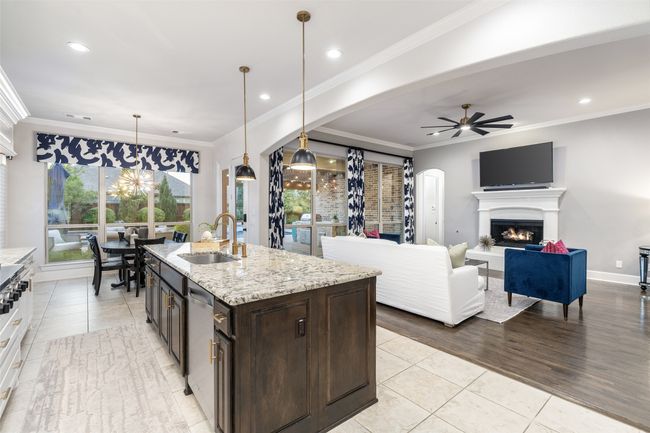 Kitchen is open to the living room and eating area. Take note of all the upgraded light fixtures as no detail was left out of this homes finishes and upgrades. | Image 13
