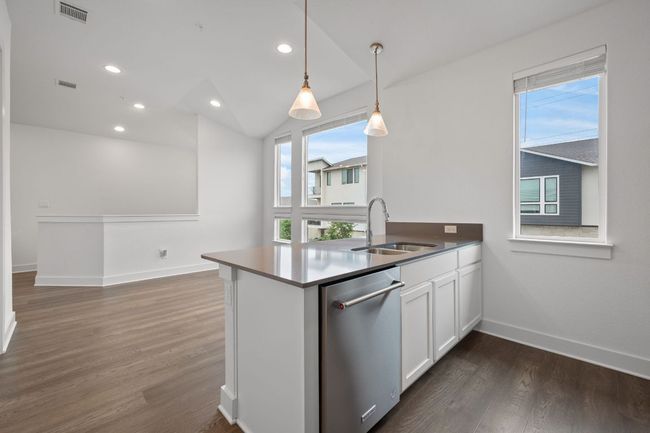 Kitchen with dishwasher, white cabinetry, a peninsula, dark wood-style flooring, and recessed lighting | Image 7