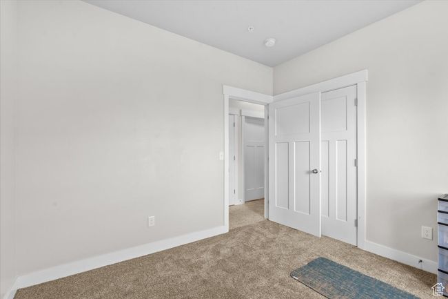 Unfurnished bedroom with carpet flooring and baseboards | Image 9