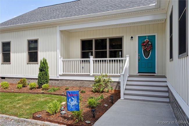 Entrance to property with roof with shingles and a porch | Image 6