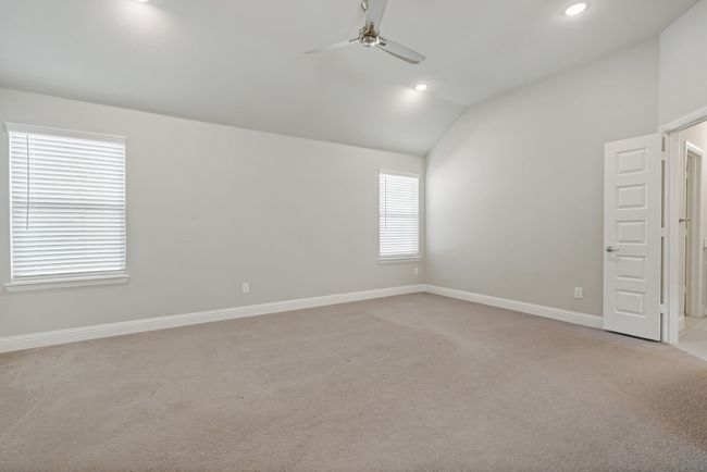 Spare room featuring baseboards, recessed lighting, a ceiling fan, lofted ceiling, and light colored carpet | Image 18