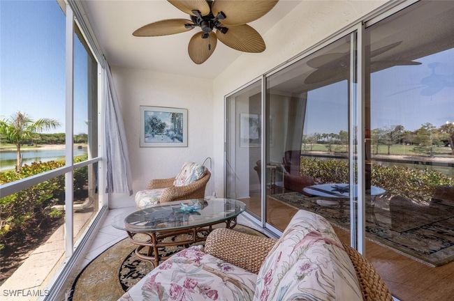 Sunroom with a water view and ceiling fan | Image 19
