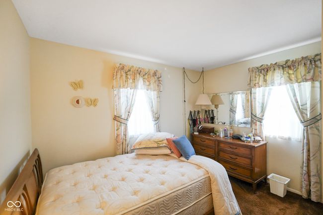 bedroom featuring multiple windows and dark colored carpet | Image 20