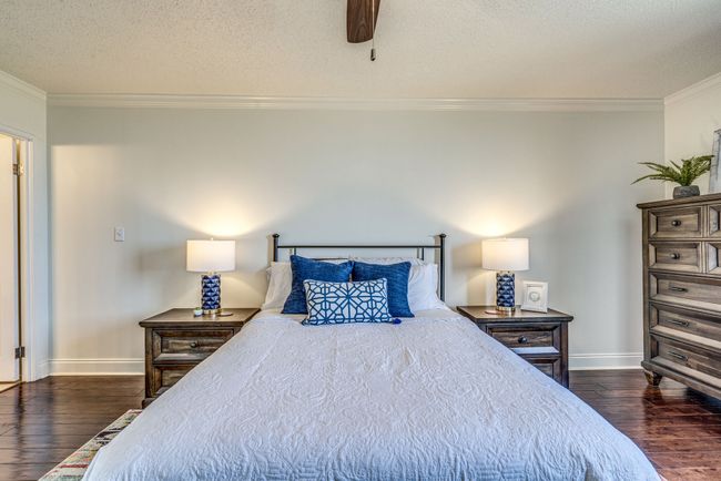 Whether you're starting your day or winding down in the evening, the primary bedroom with its warm hardwood floors, walk-in closet, and private bath is the perfect place to retreat. | Image 14