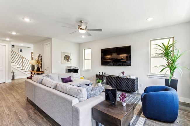 Living area with stairs, wood finished floors, a ceiling fan, and recessed lighting | Image 37