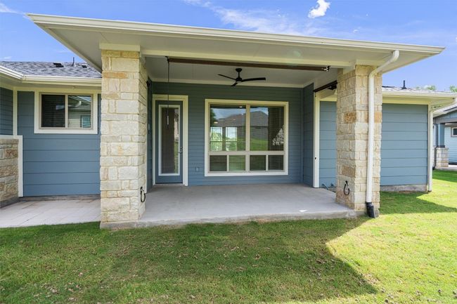 Covered back patio overlooking the backyard. The patio has an extension to one side. Yard maintenance is included in the HOA. | Image 22