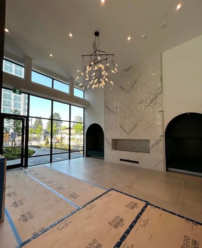 Unfurnished living room with an inviting chandelier, a healthy amount of sunlight, and recessed lighting | Image 27