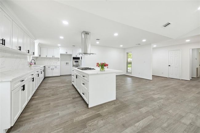 A view of the kitchen from the den. | Image 9