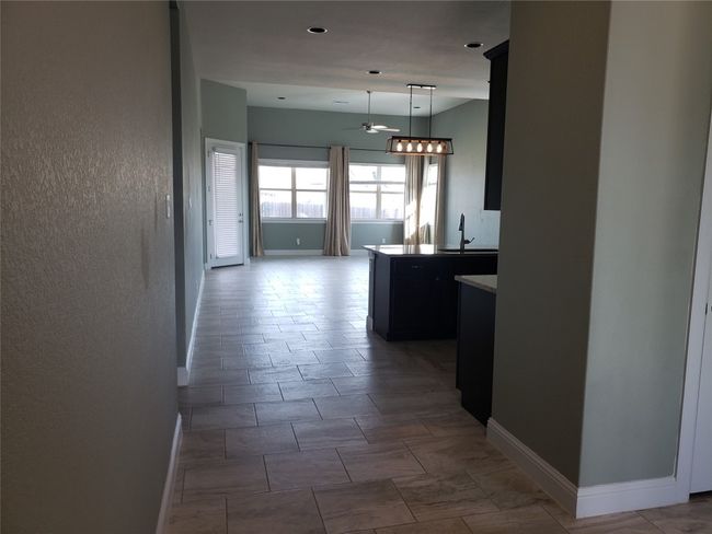 Corridor featuring a sink and baseboards | Image 6