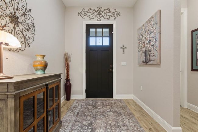 Foyer with light wood look tile floors | Image 5