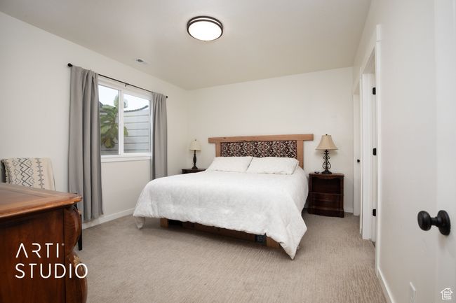 Bedroom featuring light carpet | Image 38