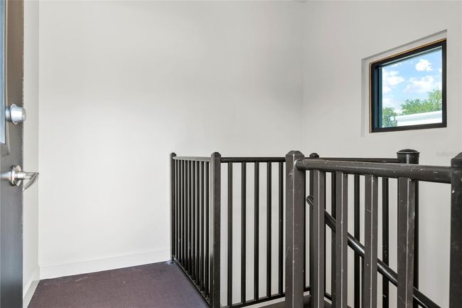 TOP OF SPIRAL STAIRCASE AT DOOR LEADING TO ROOFTOP DECK | Image 9