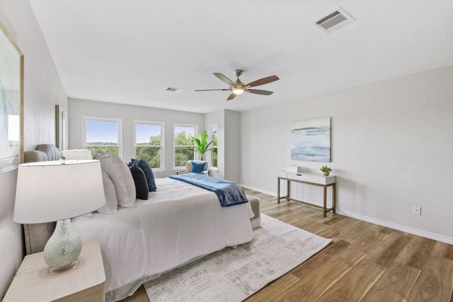 Bedroom featuring wood finished floors, baseboards, and a ceiling fan | Image 36