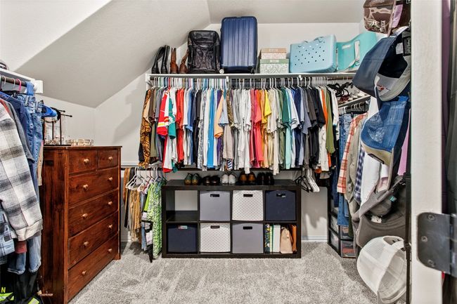 Walk in closet with carpet floors and vaulted ceiling | Image 18