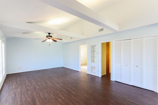 Washer and dryer behind louvered doors in den | Image 11