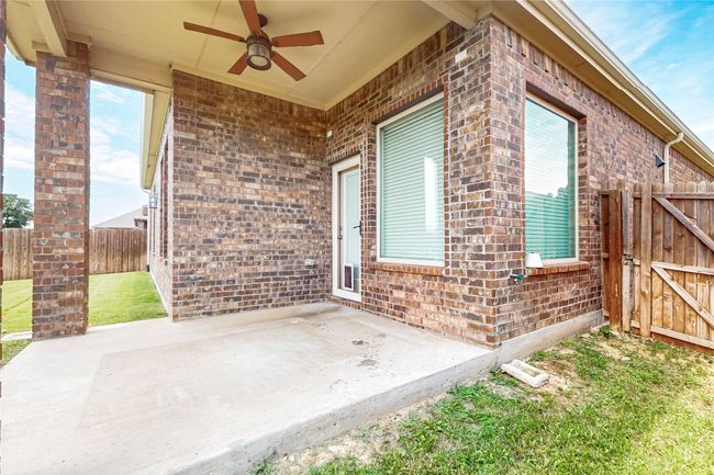 View of patio / terrace with a ceiling fan and a gate | Image 35