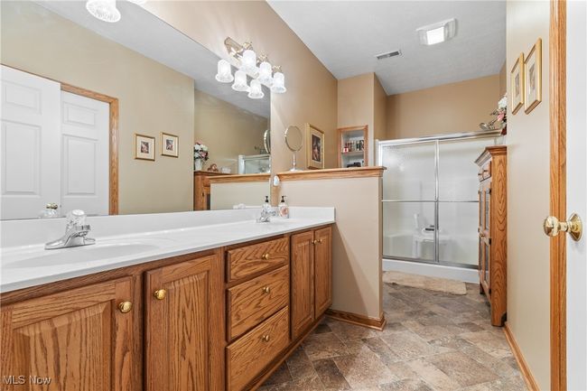 Primary bath boasts double sinks and step-in shower. | Image 17