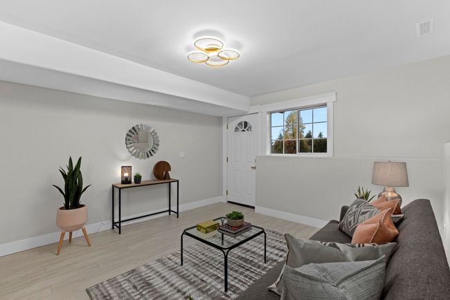 Living area featuring visible vents, baseboards, and light wood-style floors | Image 31