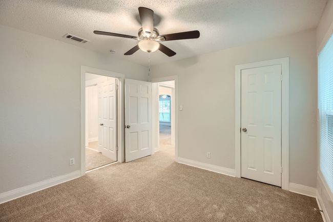 Unfurnished bedroom featuring a textured ceiling, visible vents, connected bathroom, and carpet floors | Image 24