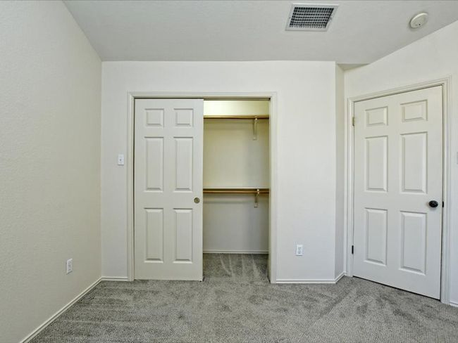 Unfurnished bedroom with carpet floors, baseboards, a closet, and visible vents | Image 14