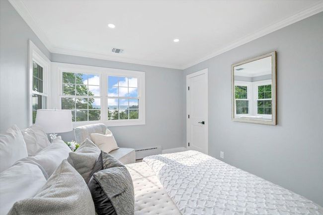 Bedroom with ornamental molding, recessed lighting, and a baseboard heating unit | Image 19