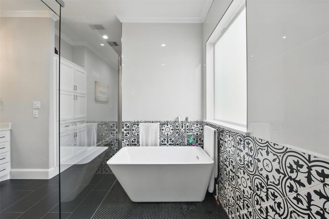 Elegant spa like multiheaded shower with enclosed tub to keep you warm while you soak. | Image 20