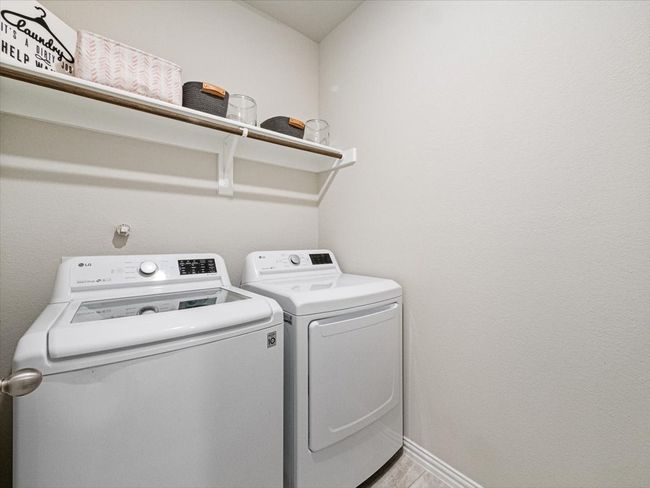 Washroom featuring laundry area, baseboards, and washer and clothes dryer | Image 22