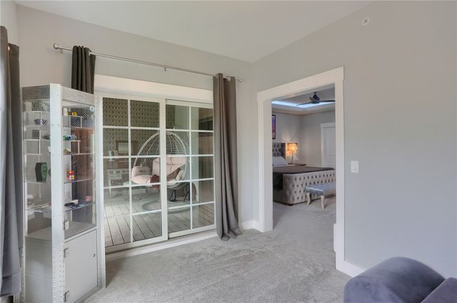 Currently being used as a dressing room with access to the private deck, this space is part of the Primary Bedroom and can be used as a second office, spa room, dressing room or anything you want it to be! | Image 33