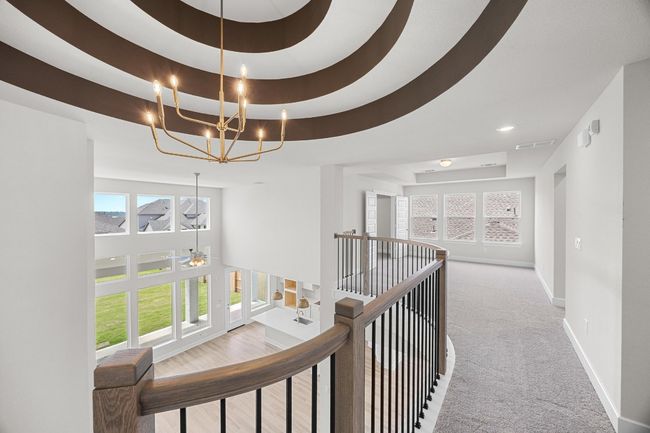 Hallway with an upstairs landing, carpet, baseboards, a chandelier, and healthy amount of natural light | Image 20