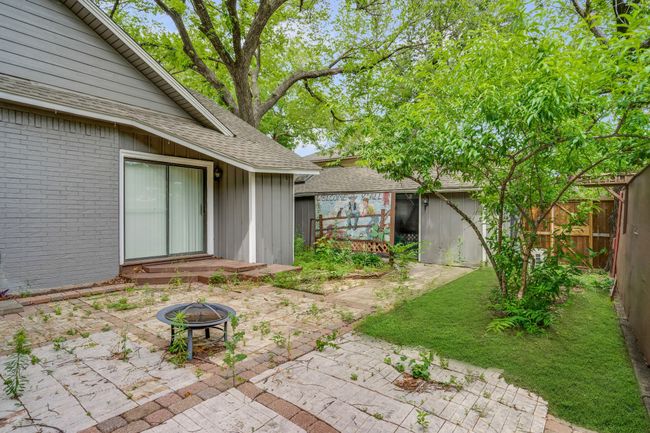 View of yard featuring a patio, a fire pit, and an outbuilding | Image 29