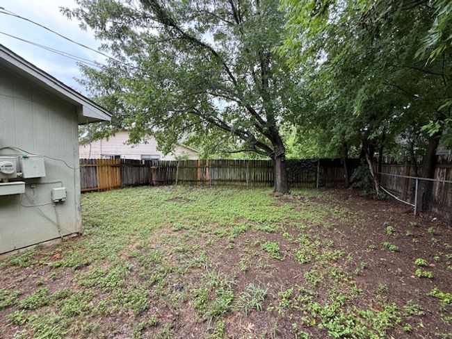 View of fenced backyard | Image 14