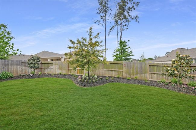 Lush maple trees enhance the serene beauty of this backyard oasis. | Image 36