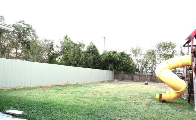 Enjoy privacy in your newly fenced backyard, complete with durable metal fencing. | Image 47