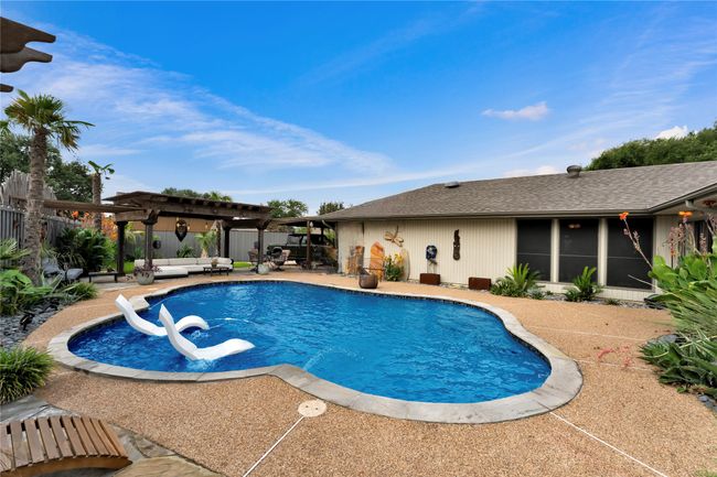 View of swimming pool with a pergola, a patio area, and an outdoor hangout area | Image 31