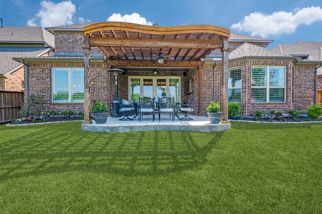 Extended covered back patio with pergola is spacious and a perfect space to enjoy those Texas evenings. | Image 32
