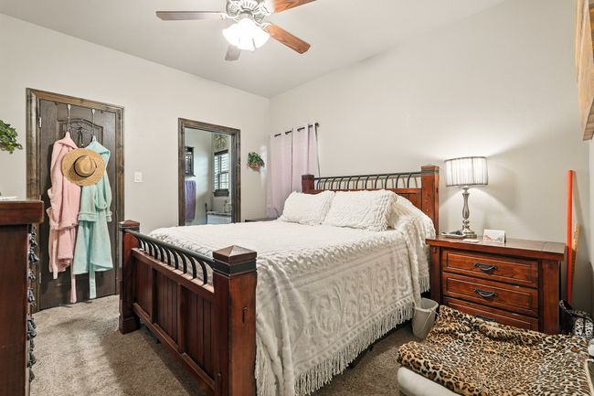 Carpeted bedroom featuring ceiling fan | Image 20